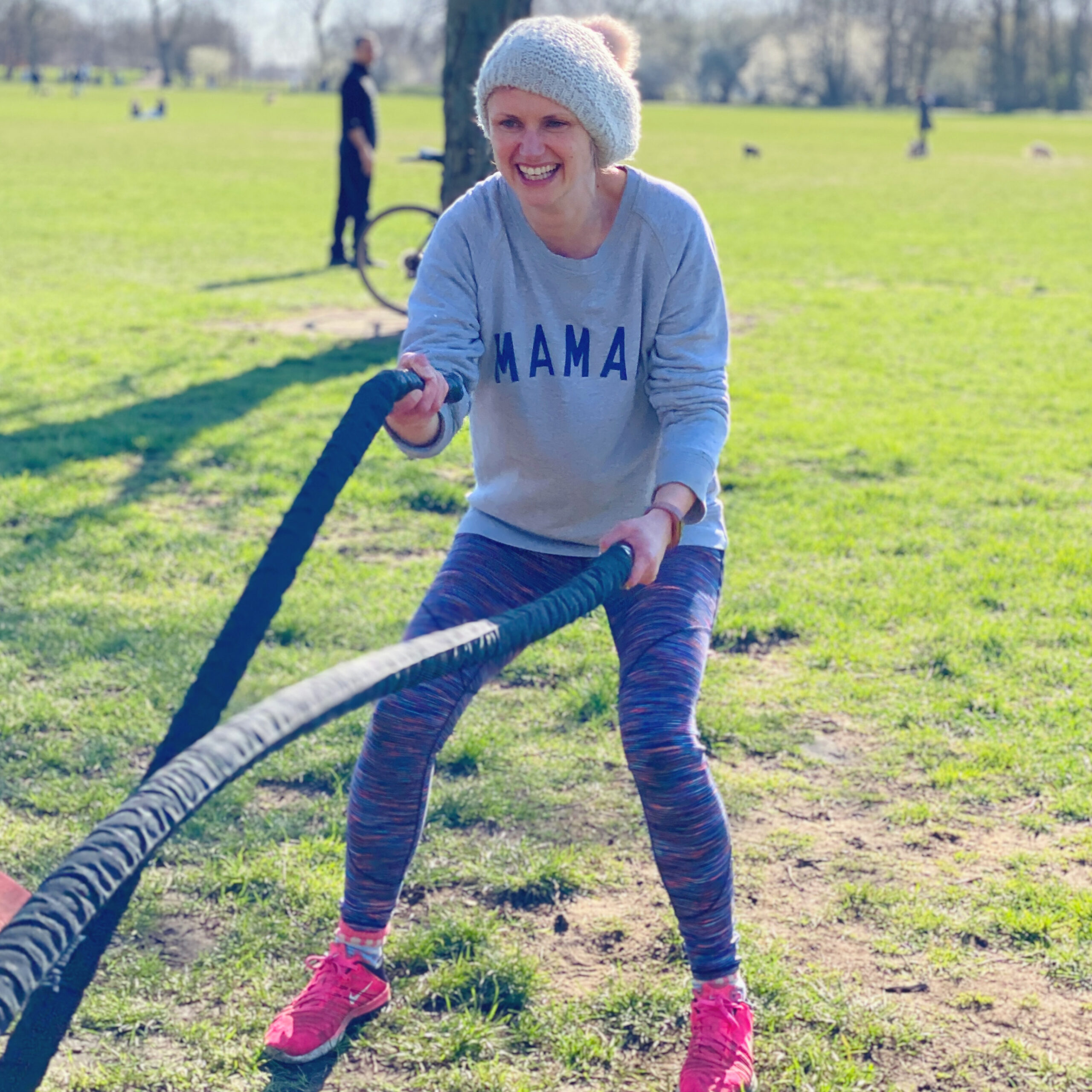 Mum training with battle ropes during outdoor fitness class in Clapham Common