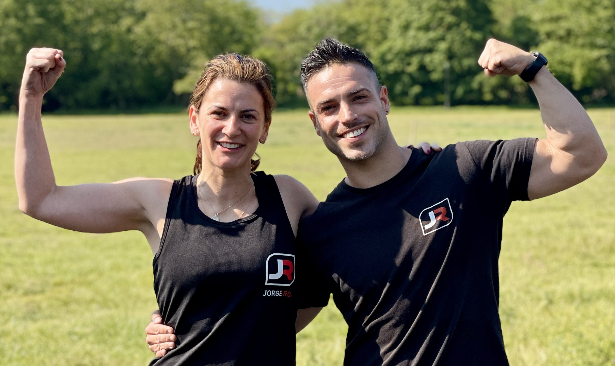 Personal trainer and client smiling after outdoor fitness session in Clapham Common showing progress