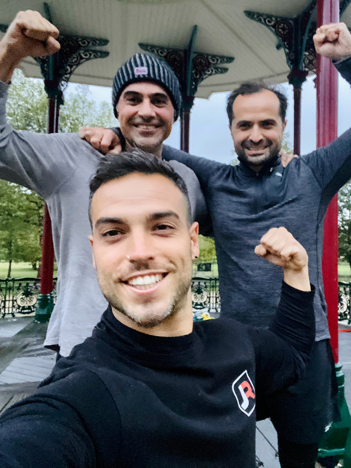 Personal trainer with clients after training session in Battersea Park bandstand showing results