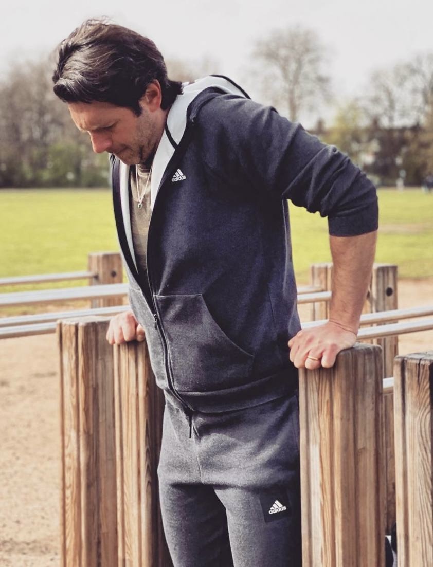 Client performing dips during outdoor personal training session in Battersea Park