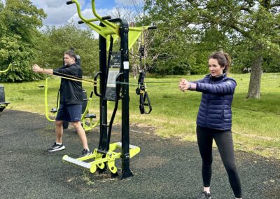 2-to-1 outdoor personal training session with a couple doing core exercises at Clapham Common Outdoor Gym