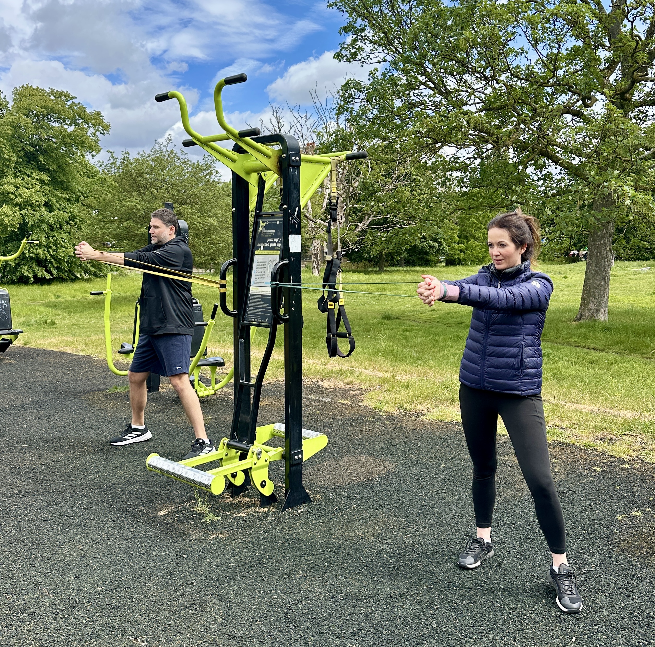 2-to-1 outdoor personal training session with a couple doing core exercises at Clapham Common Outdoor Gym