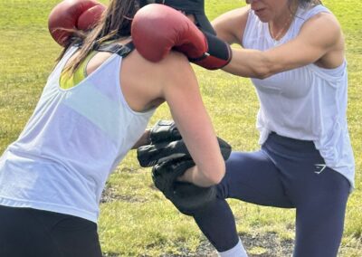 Two women doing boxing drills during outdoor bootcamp training in Clapham Common Fitness Area 3